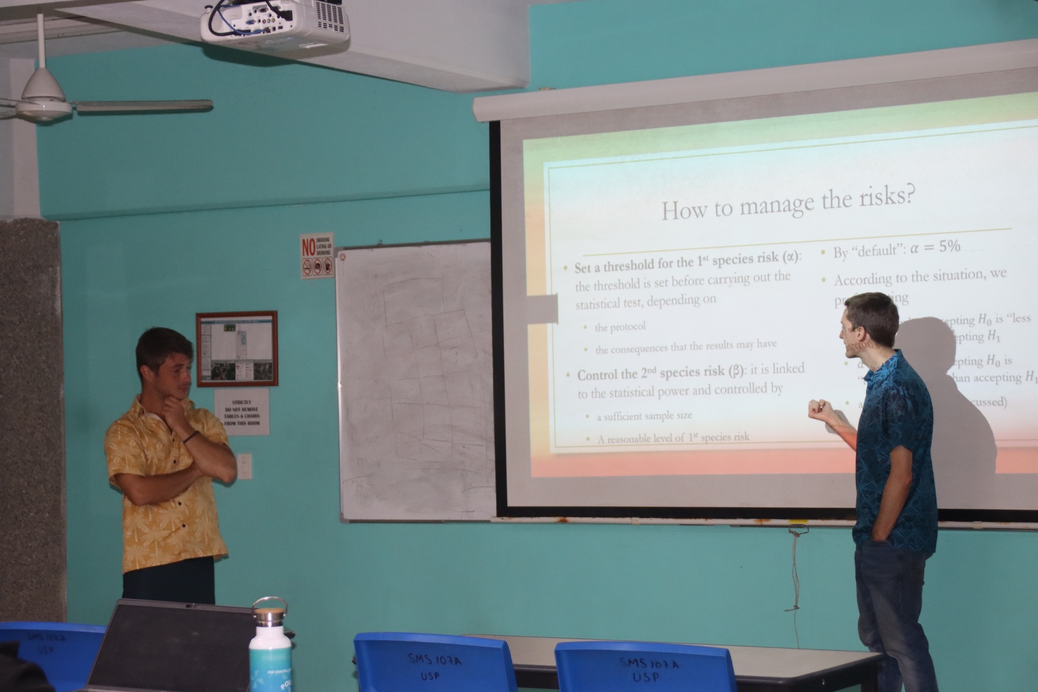 G. Wattelew and J. Brouillon presenting their R slide powerpoint on the screen